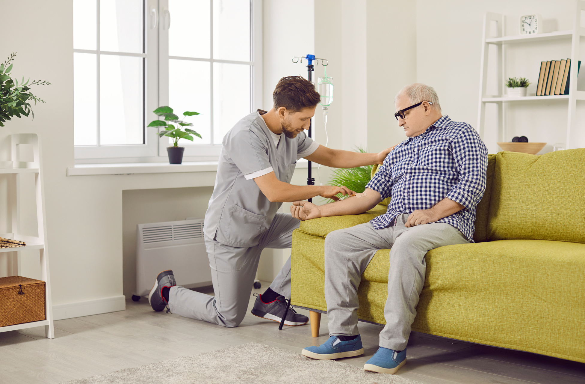 Male Caregiver Setting up Iv Drip to Senior Patient